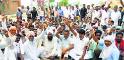 Labourers and arhtiyas protest at Mogas Baghapurana area on Saturday. Tribune photo
