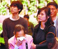 A woman cries as she pays tribute to the victims of the sunken ferry at a group memorial altar in Ansan on Saturday. AP/PTI