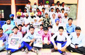 Students of Government School, Khasa, hold anti-drug abuse posters at a seminar organised by the BSF.