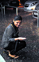 A girl collects hail
