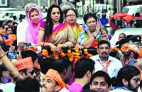 BJP leader Hema Malini and Tehri candidate Mala Raj Lakshmi during a rally in Dehradun on Sunday. A Tribune photograph