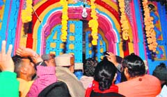 Pilgrims and priests during the religious ceremony for the opening of the portals of the Kedarnath shrine in Rudraprayag district on Sunday. A Tribune photograph