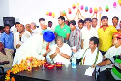 Venod Sharma acknowledges greetings from an elder supporter at the opening of an office at Assandh in Karnal district on Sunday. Tribune photo: Parveen Arora