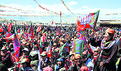 Party workers and BJP supporters participate in a rally at the Polo Ground on the second last day of the campaigning in Leh on Sunday
