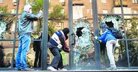 Pro-Russian activists break the glass of the offices of Industrial Union of Donbass Corporation in Donetsk on Sunday.