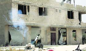 Free Syrian Army fighters fire a rocket launcher towards forces loyal to Syrias President Bashar Al-Assad in Mork town.