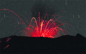 Mount Slamet spews hot lava from its crater as seen from Paguyangan, Central Java, Indonesia, on Sunday.