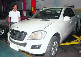 Businessman Gagan Chhabra stands next to the SUV that got stuck at a waterlogged underpass (right) in the Industrial Area, Phase I, Chandigarh, after Sunday evening’s storm