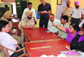Employees of the post office narrate the robbery incident to police officials at Dera Bassi on Monday