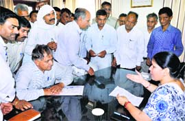 Haryana Education Minister Geeta Bhukkal interacts with schoolteachers after receiving their memorandum in Jhajjar.