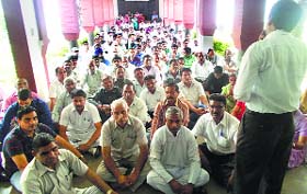 Members of the Kurukshetra University Non-Teacher Employees Association stage a dharna outside Vice-Chancellor DDS Sandhus office on the university premises on Monday.
