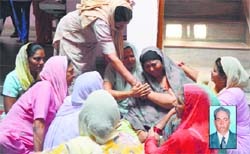 Members of victim Surjit Singhs (inset) family and relatives grieve in Ludhiana on Monday. Tribune photo