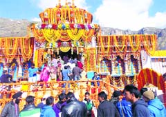Devotees wait to offer prayers at the Badrinath shrine on Monday. PTI