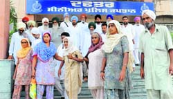 Family members of Lachaman outside the SSPs office in Bathinda. Tribune photo