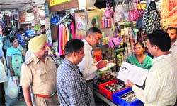 Officials of the UT Estate Office conduct an ownership verification drive at the Krishna Market, Sector 41, Chandigarh, on Tuesday. Tribune photo: Majon Mahajan