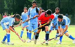 Players vie to take control of the ball in the Fourth Inter School Girls Invitational Hockey Tournament played at Welham Girls School in Dehradun on Tuesday