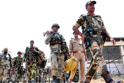 BSF soldiers move towards their vehicles for election duty at the Parade ground in Dehradun ahead of Lok Sabha elections