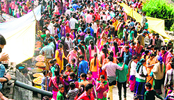 Devotees seek blessings at the Bhadraj temple amid beating of traditional drums at the Dhan Bhadraj fair in Tehri district on Tuesday