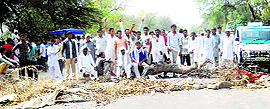 Villagers block a road in protest against erratic water supply to their village at Munnawali in Sirsa on Tuesday