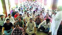 Members of the Kurukshetra University Non-Teaching Employees Association stage a dharna outside Vice-Chancellor DDS Sandhus office on the university premises on Tuesday