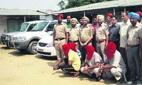 Police officials along with the nabbed highway robbers in Jalandhar on Tuesday