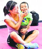 Mary Kom, who will be in action on Wednesday, with her son during the trials in New Delhi on Tuesday.