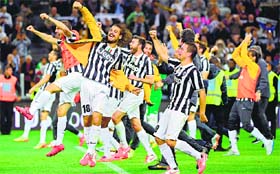 Juventus players celebrate at the end of their Serie A match against Atalanta on Monday in Turin. Juventus won their third consecutive and 30th official Serie A title.