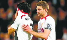Liverpools Steven Gerrard shepherds Luis Suarez from the field at the end of their Premier League match against Crystal Palace in London on Monday.