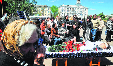 People mourn during the funeral ceremony of a pro-Russian activist killed during combat with Ukrainian troops in Kramatorsk, eastern Ukraine, on Tuesday.
