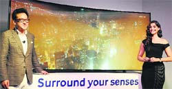 Actress Sonam Kapoor and Samsung India managing director SK Kim unveil a curved UHD TV in New Delhi on Wednesday. Tribune photo: Mukesh Aggarwal