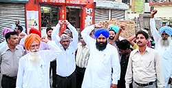 Residents shout slogans outside the liquor vend in Bathinda on Wednesday
