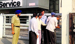 Officials of the Estate Office seal the premises of Harmony Honda in the Industrial Area, Phase II, Chandigarh, on Wednesday