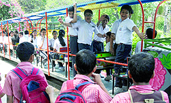 Children enjoy the toy train trip at Bal Bhawan near ITO in New Delhi on Wednesday