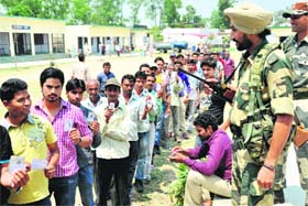 MAKING IT COUNT: People stand in a queue to cast their votes in Dehradun on Wednesday