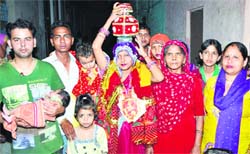 Rakhi with her husband Bijender Singh (holding the newborn), mother-in-law, two daughters and other family members during a ceremony at Pritamp
