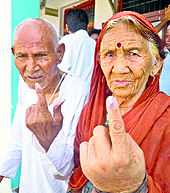 Displaced Kashmiri Pandits show their ink-marked finger after casting their vote for the Baramulla seat in Jammu on Wednesday