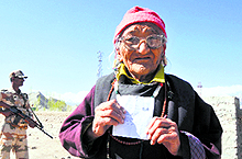 An old woman shows her voter ID card before exercising her franchise at the Housing Colony polling station in Leh on Wednesday