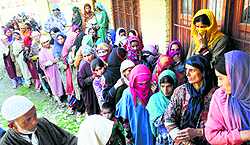 Women await their turn to cast their vote in Kupwara
