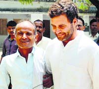 Congress candidate from Amethi Rahul Gandhi interacts with a voter near a polling booth in Amethi on Wednesday. PTI