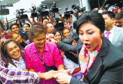 Thai Prime Minister Yingluck Shinawatra meets her supporters in Bangkok on Wednesday.  AP/PTI