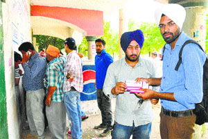Residents buy tickets at a counter of the Punjab Cricket Association Stadium ahead of the IPL match in Mohali.