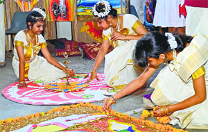 Students take part in a rangoli competition at St Johns High School on Thursday.