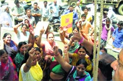 Residents protest against a liquor vend in their locality near Agarsen Chowk in Sirsa on Wednesday. A Tribune photograph