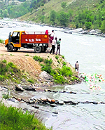 A PWD truck dumps waste alleged to be Congress campaign material of Sonia Gandhi's recent rally directly into the Beas near Pirdi on Wednesday