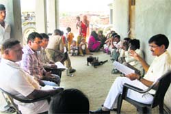 Assandh SDM Vir Singh talks to the people during a search operation at a village in Karnals Rahra on Thursday. Tribune photo
