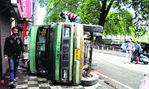 A passenger bus that had overturned on the Residency Road in Srinagar on Thursday. Eight  persons were injured in the incident.