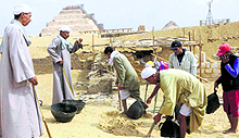 Workers dig at the site of a newly-discovered tomb dating to around 1100 BC at the Saqqara archaeological site in Egypt on Thursday