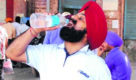 With no proper provision for drinking water, applicants bring their water along.