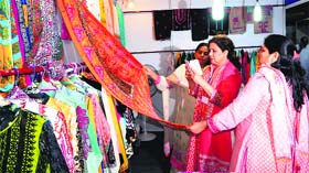 Women have a look at clothes during The Pakistan Show at Trillium Mall in Amritsar on Friday.