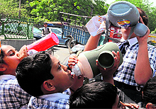 Schoolchildren sip water on a hot day in Bathinda